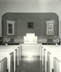 A black and white photo of the interior of the old church