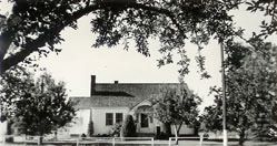 A black and white photo of the original church parsonage.