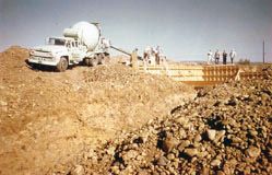 A cement truck pouring the foundation for the new church building